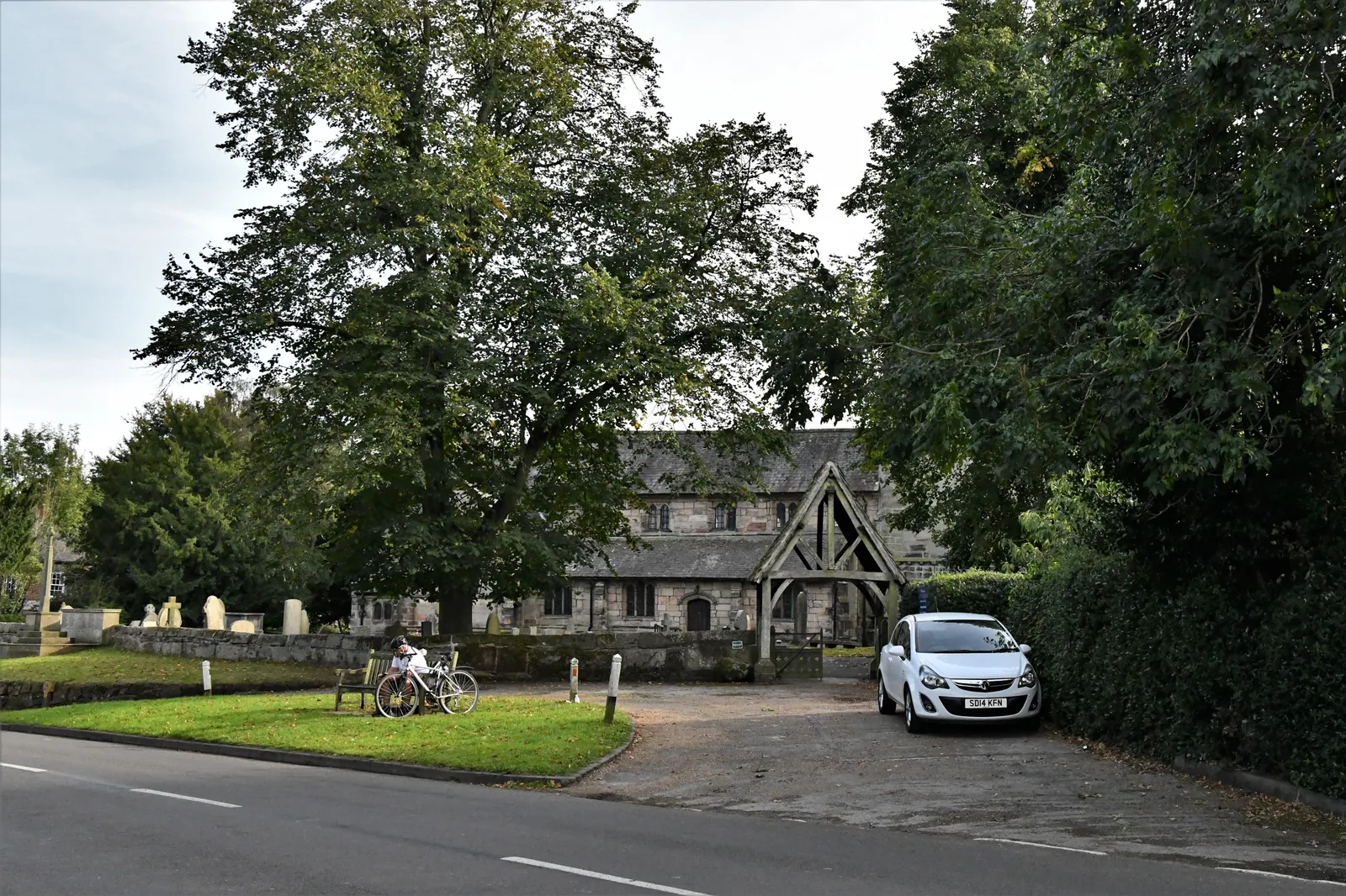 St Wilfrid’s Church in Mobberley, with its timber porch and trees around the churchyard