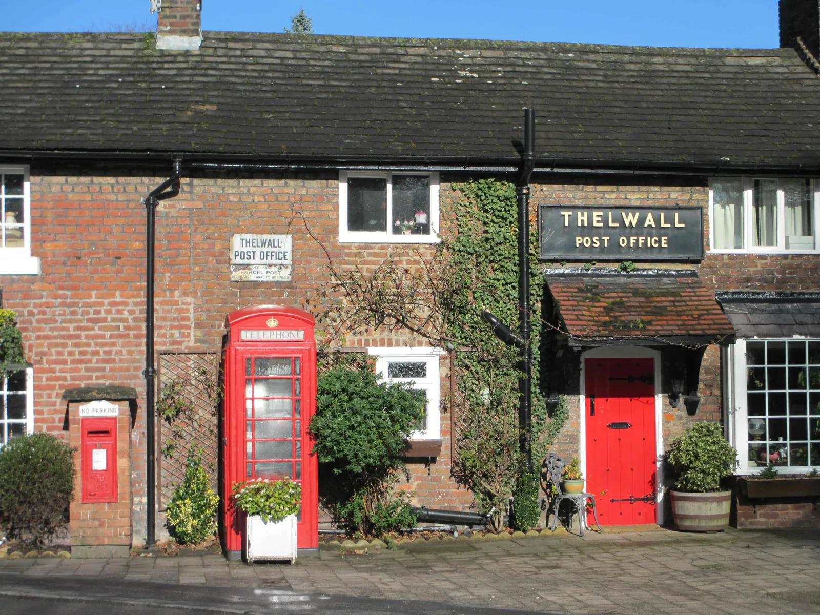 Thelwall’s old post-office building with its red telephone kiosk and post box
